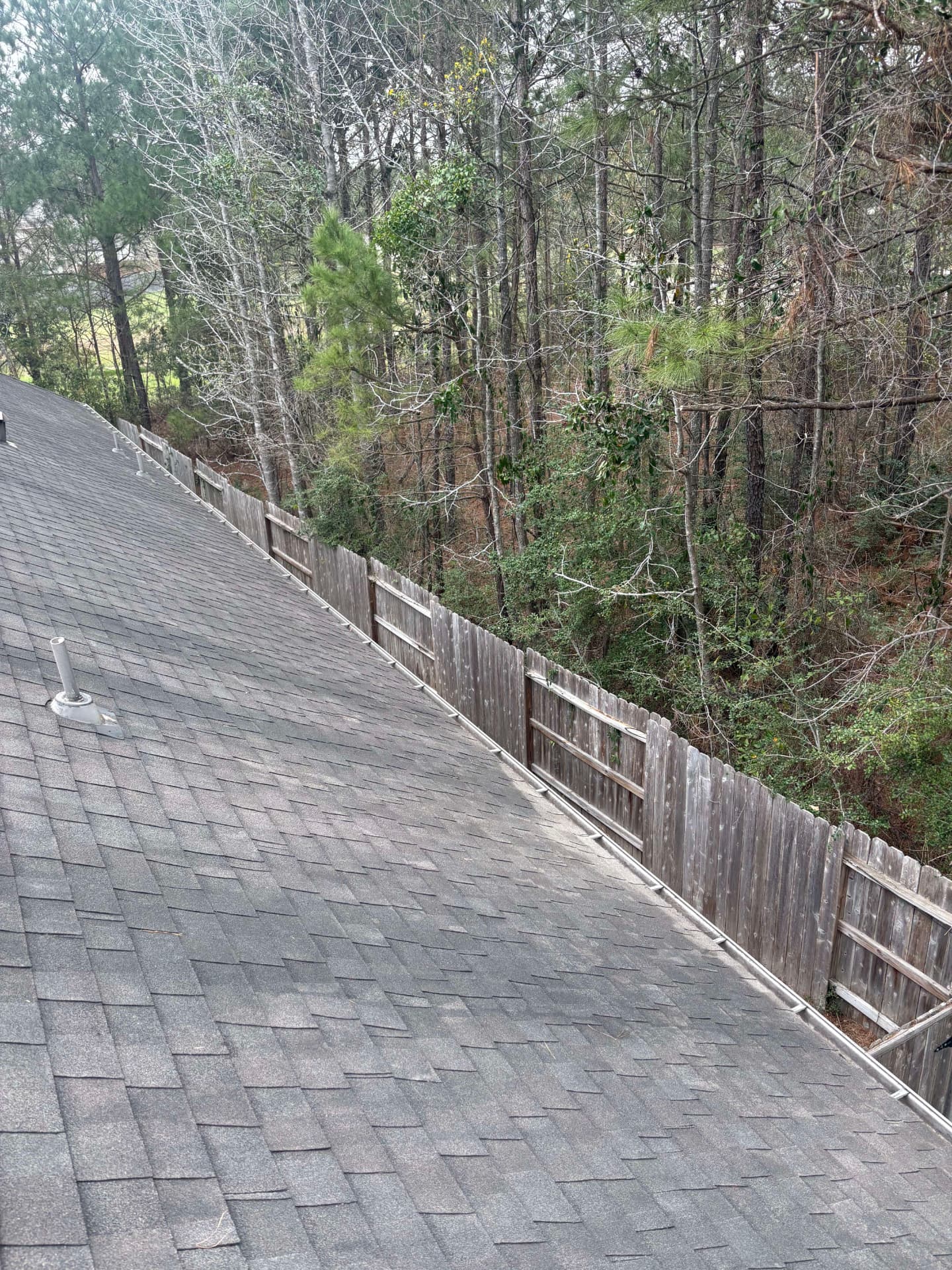 Roof with a fence line in the background — Integrative Services, Montgomery TX